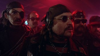 Movie still from “Pee-wee's Big Adventure” (1985), directed by Tim Burton – A group of men in leather jackets and sunglasses; Close Up shot, Low angle