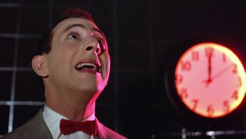 Movie still from “Pee-wee's Big Adventure” (1985), directed by Tim Burton – A person wearing a suit and tie; Close Up shot, Low angle
