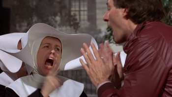 Movie still from “Pee-wee's Big Adventure” (1985), directed by Tim Burton – A man and a woman are yelling at each other; Close Up shot, Over the shoulder angle