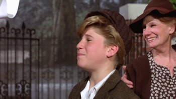 Movie still from “Pee-wee's Big Adventure” (1985), directed by Tim Burton – A young man wearing a brown hat and a brown jacket; Close Up shot, Over the shoulder angle