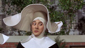 Movie still from “Pee-wee's Big Adventure” (1985), directed by Tim Burton – A man in a nun's outfit with a surprised look on his face; Close Up shot, High angle
