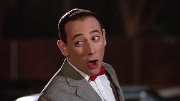 Movie still from “Pee-wee's Big Adventure” (1985), directed by Tim Burton – A person wearing a suit and tie; Close Up shot, Low angle