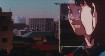 Movie still from “Perfect Blue” (1997), directed by Kô Matsuo – A large mural of a woman's face on the side of a building; Extreme Close Up shot, Low angle