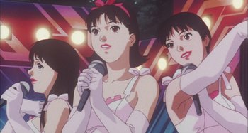 Movie still from “Perfect Blue” (1997), directed by Kô Matsuo – A person holding a microphone in front of another person; Close Up shot, Low angle