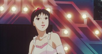 Movie still from “Perfect Blue” (1997), directed by Kô Matsuo – A woman with a pink bow in front of lights; Close Up shot, Low angle