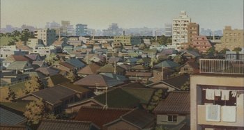 Movie still from “Perfect Blue” (1997), directed by Kô Matsuo – An aerial view of a city with many rooftops; Extreme Wide shot, High angle