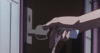 Movie still from “Perfect Blue” (1997), directed by Kô Matsuo – A hand is holding a key to a lock; Extreme Close Up shot, High angle