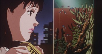 Movie still from “Perfect Blue” (1997), directed by Kô Matsuo – A woman's face in front of plants; Close Up shot, Low angle