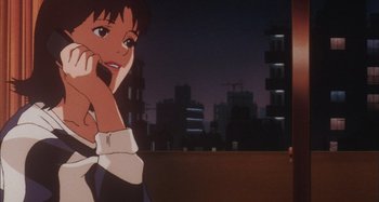 Movie still from “Perfect Blue” (1997), directed by Kô Matsuo – A woman standing in front of a city at night; Close Up shot, Low angle