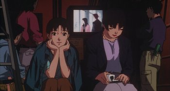 Movie still from “Perfect Blue” (1997), directed by Kô Matsuo – Two people sitting next to each other in front of a television; Medium shot, High angle