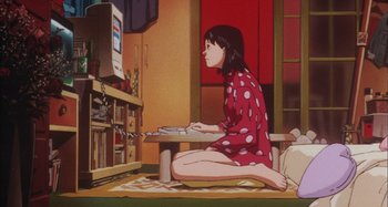 Movie still from “Perfect Blue” (1997), directed by Kô Matsuo – A woman sitting on the ground in front of a computer monitor; Wide shot, High angle