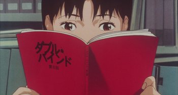 Movie still from “Perfect Blue” (1997), directed by Kô Matsuo – A person reading a red book; Extreme Close Up shot, High angle