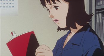 Movie still from “Perfect Blue” (1997), directed by Kô Matsuo – An animated picture of a woman holding a red book; Close Up shot, Low angle