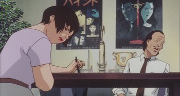Movie still from “Perfect Blue” (1997), directed by Kô Matsuo – An animated scene of a person writing on a paper; Medium shot, High angle