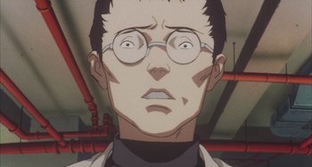 Movie still from “Perfect Blue” (1997), directed by Kô Matsuo – A man with glasses is looking at the camera; Close Up shot, Low angle