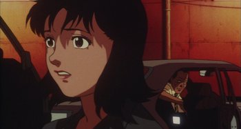 Movie still from “Perfect Blue” (1997), directed by Kô Matsuo – A woman's face in front of a man; Close Up shot, Over the shoulder angle