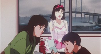 Movie still from “Perfect Blue” (1997), directed by Kô Matsuo – Two women and a boy are sitting at a table; Medium shot, Low angle