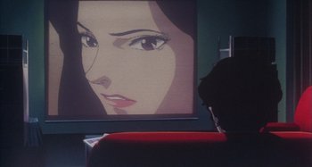 Movie still from “Perfect Blue” (1997), directed by Kô Matsuo – A person sitting in front of a television screen; Extreme Close Up shot, Over the shoulder angle