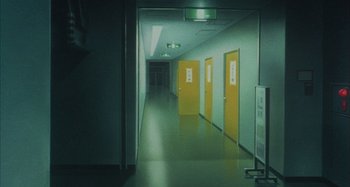 Movie still from “Perfect Blue” (1997), directed by Kô Matsuo – A hallway with three yellow doors and a green light above it; Extreme Wide shot, High angle