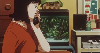 Movie still from “Perfect Blue” (1997), directed by Kô Matsuo – A woman talking on a phone in front of a fish tank; Close Up shot, High angle
