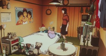 Movie still from “Perfect Blue” (1997), directed by Kô Matsuo – A woman standing next to a bed in a room; Wide shot, High angle