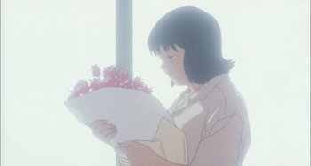 Movie still from “Perfect Blue” (1997), directed by Kô Matsuo – A woman holding a bouquet of flowers in her hands; Close Up shot, Low angle