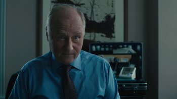 Movie still from “Philomena” (2013), directed by Stephen Frears – An older man wearing a blue dress shirt and tie; Close Up shot, Over the shoulder angle