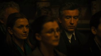 Movie still from “Philomena” (2013), directed by Stephen Frears – A group of people sitting next to each other in a dark room; Close Up shot, Over the shoulder angle