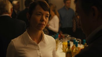 Movie still from “Philomena” (2013), directed by Stephen Frears – A woman sitting at a table with a bottle of wine in front of her; Close Up shot, Over the shoulder angle