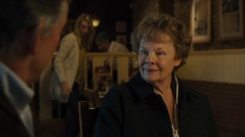 Movie still from “Philomena” (2013), directed by Stephen Frears – An older woman sitting at a table in a restaurant; Close Up shot, Over the shoulder angle