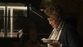 Movie still from “Philomena” (2013), directed by Stephen Frears – An older woman holding a plate in her hands; Close Up shot, High angle