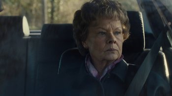 Movie still from “Philomena” (2013), directed by Stephen Frears – An older woman sitting in the back seat of a car; Close Up shot, Over the shoulder angle