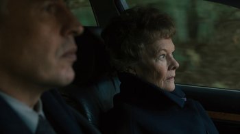 Movie still from “Philomena” (2013), directed by Stephen Frears – An older man and woman sitting in the back of a car; Close Up shot, High angle