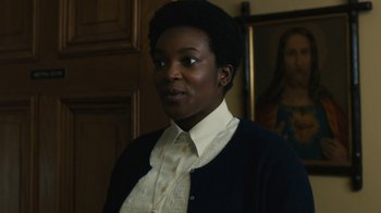 Movie still from “Philomena” (2013), directed by Stephen Frears – A woman in a white shirt and black sweater; Close Up shot, Over the shoulder angle