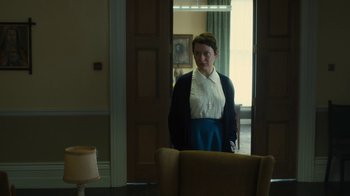 Movie still from “Philomena” (2013), directed by Stephen Frears – A woman standing in front of a chair in a room; Medium shot, Low angle