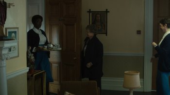 Movie still from “Philomena” (2013), directed by Stephen Frears – Two women in a room with a painting on the wall behind them; Medium shot, Over the shoulder angle