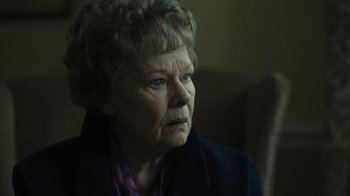 Movie still from “Philomena” (2013), directed by Stephen Frears – An older woman looking at the camera while sitting down; Close Up shot, Over the shoulder angle