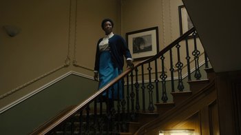Movie still from “Philomena” (2013), directed by Stephen Frears – A woman standing on the bottom of a staircase; Wide shot, Low angle