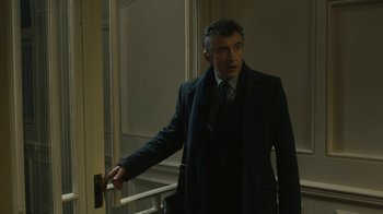 Movie still from “Philomena” (2013), directed by Stephen Frears – A man standing in front of a window with his hand on a rail; Medium shot, Low angle