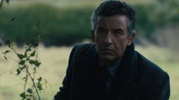 Movie still from “Philomena” (2013), directed by Stephen Frears – A person wearing a suit and tie; Close Up shot, Over the shoulder angle