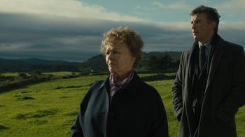 Movie still from “Philomena” (2013), directed by Stephen Frears – An older woman standing next to a man in a field; Medium shot, Low angle