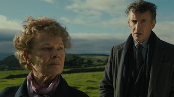 Movie still from “Philomena” (2013), directed by Stephen Frears – A man and a woman standing next to each other in a field; Close Up shot, Low angle