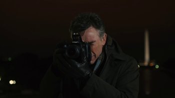 Movie still from “Philomena” (2013), directed by Stephen Frears – A man taking a picture with a camera; Close Up shot, Low angle