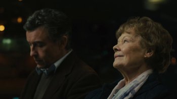 Movie still from “Philomena” (2013), directed by Stephen Frears – An older man and a younger woman sitting next to each other; Close Up shot, Over the shoulder angle