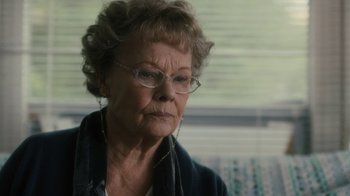 Movie still from “Philomena” (2013), directed by Stephen Frears – An older woman wearing glasses looking out of a window; Close Up shot, Over the shoulder angle