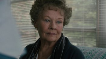 Movie still from “Philomena” (2013), directed by Stephen Frears – An older woman is looking at the camera; Close Up shot, Over the shoulder angle