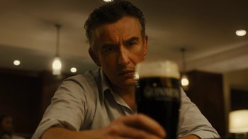 Movie still from “Philomena” (2013), directed by Stephen Frears – A person holding a beer; Close Up shot, Low angle