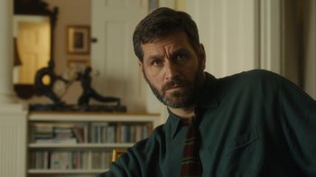 Movie still from “Philomena” (2013), directed by Stephen Frears – A person wearing a shirt and a tie; Close Up shot, Over the shoulder angle