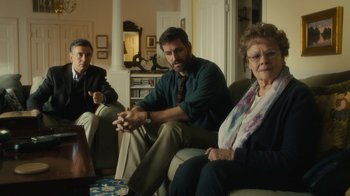 Movie still from “Philomena” (2013), directed by Stephen Frears – A group of people sitting in a living room together; Medium shot, Over the shoulder angle