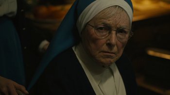 Movie still from “Philomena” (2013), directed by Stephen Frears – An older woman wearing a nun's outfit and wearing glasses; Close Up shot, High angle